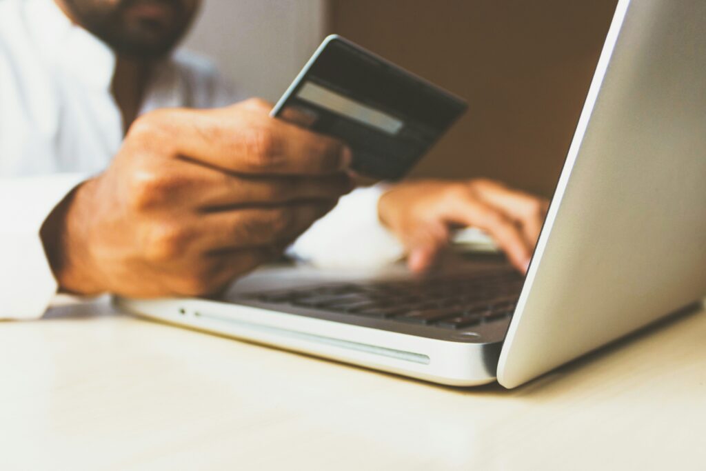 A guy entering his credit card details on a computer