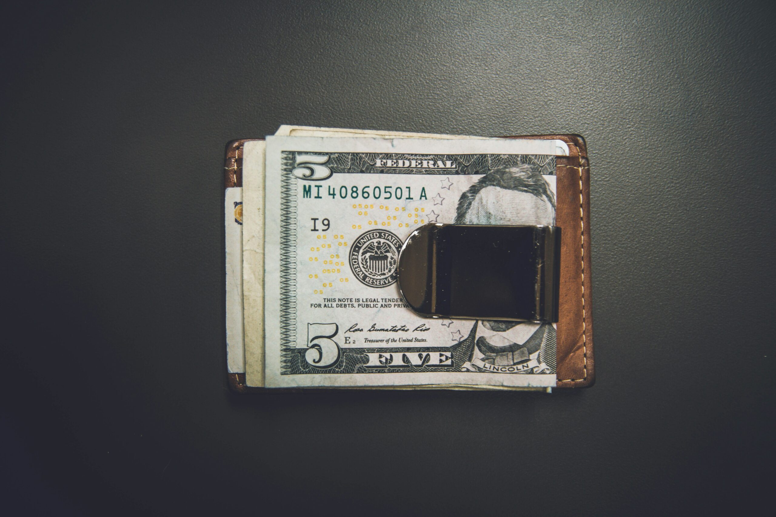 A small wad of cash in a wallet