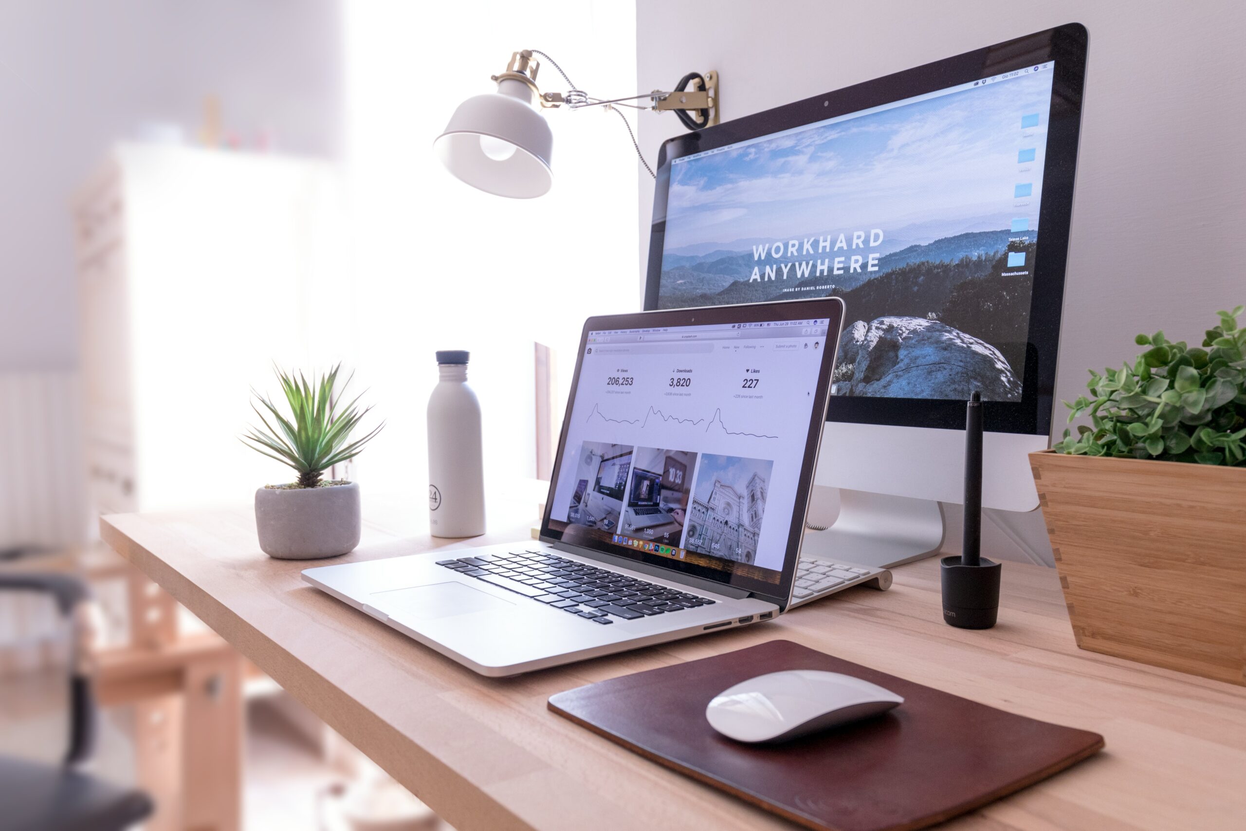 A shot of a laptop and an iMac